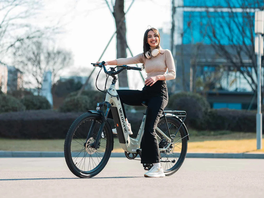 Velowave Breeze T Torque Sensor Electric Bike Woman standing next to an electric bike in an outdoor setting. Valowave Breeze T Torque Sensor Electric Bike