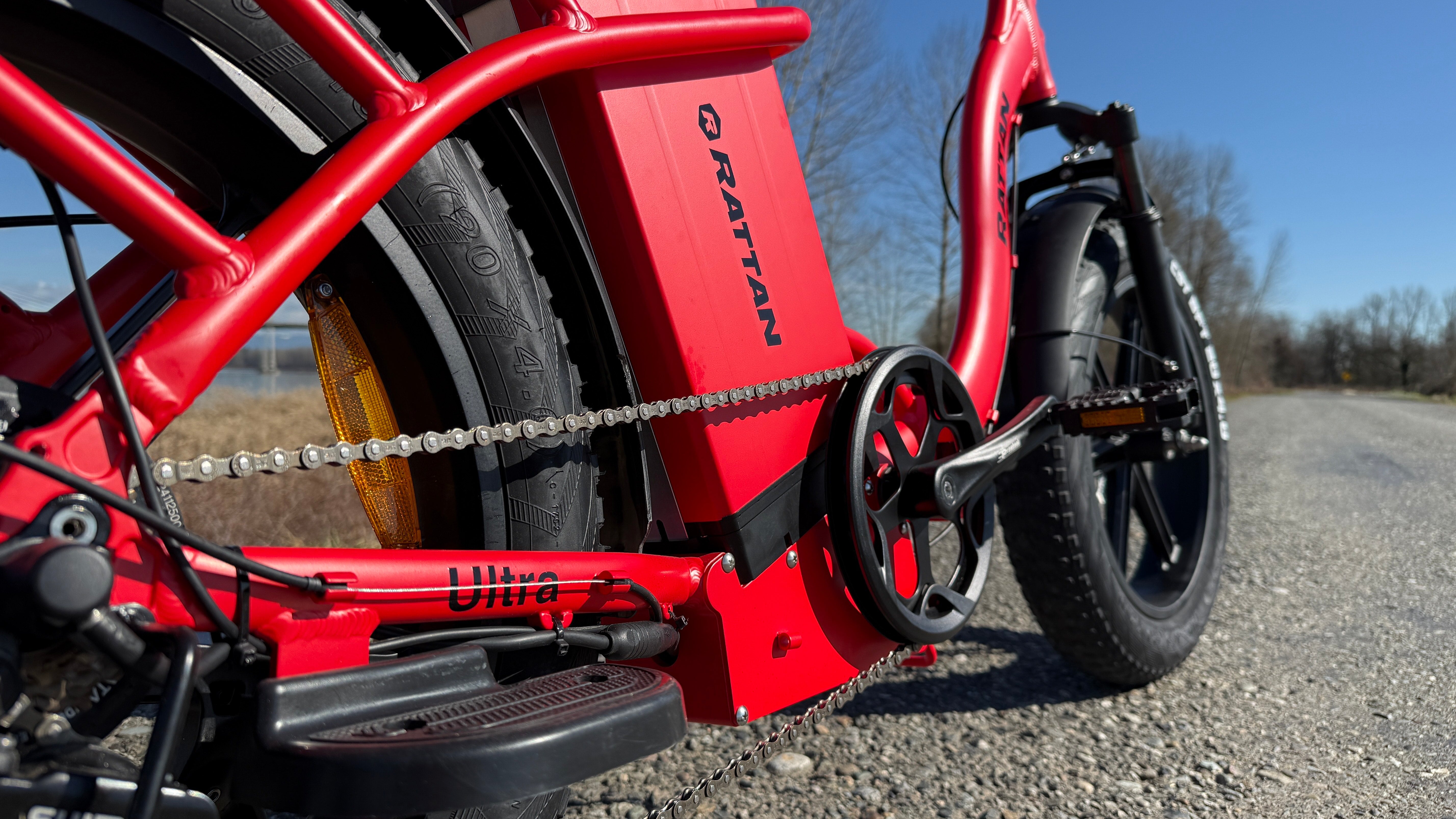 Rattan LF Ultra Folding ebike Close-up of a red electric bike on a road with a clear sky. Rattan LF Ultra Folding ebike