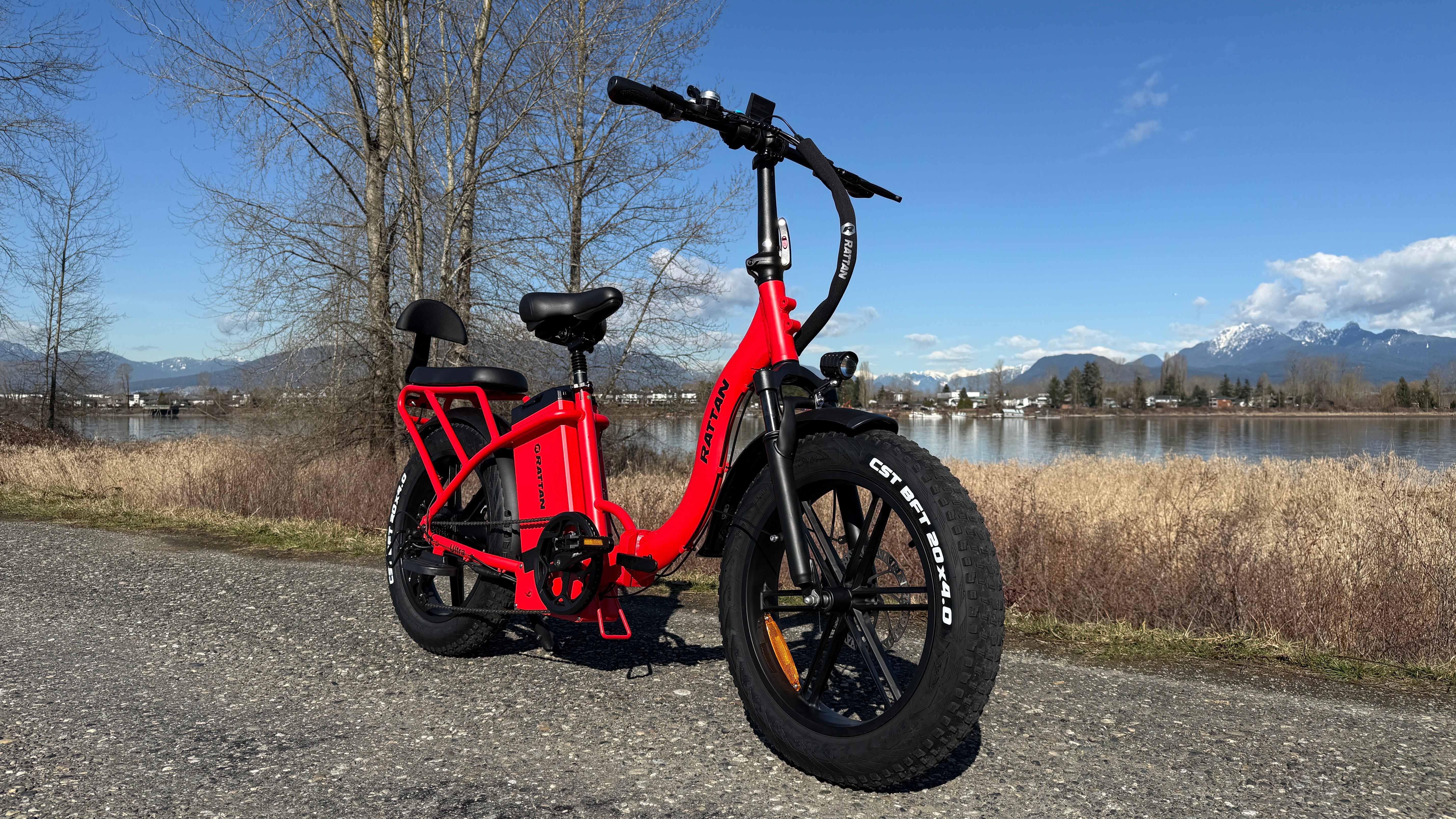 Rattan LF Ultra Folding ebike Red electric bike on a path with a scenic background of trees and mountains. Rattan LF Ultra Folding ebike