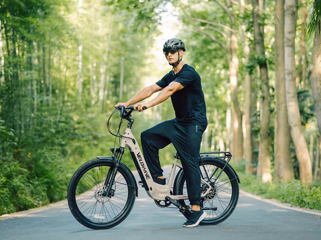 Velowave Breeze T Torque Sensor Electric Bike Person riding an electric bike on a path surrounded by trees. Valowave Breeze T Torque Sensor Electric Bike