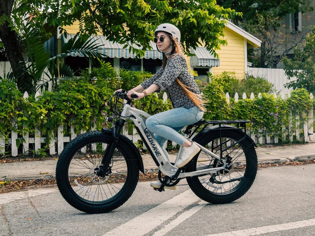 Velowave Ranger 2.0 Fat Tire All-Terrain Electric Bike Person riding a electric bike on a residential street. Valowave Ranger 2.0 Fat Tire All-Terrain Electric Bike