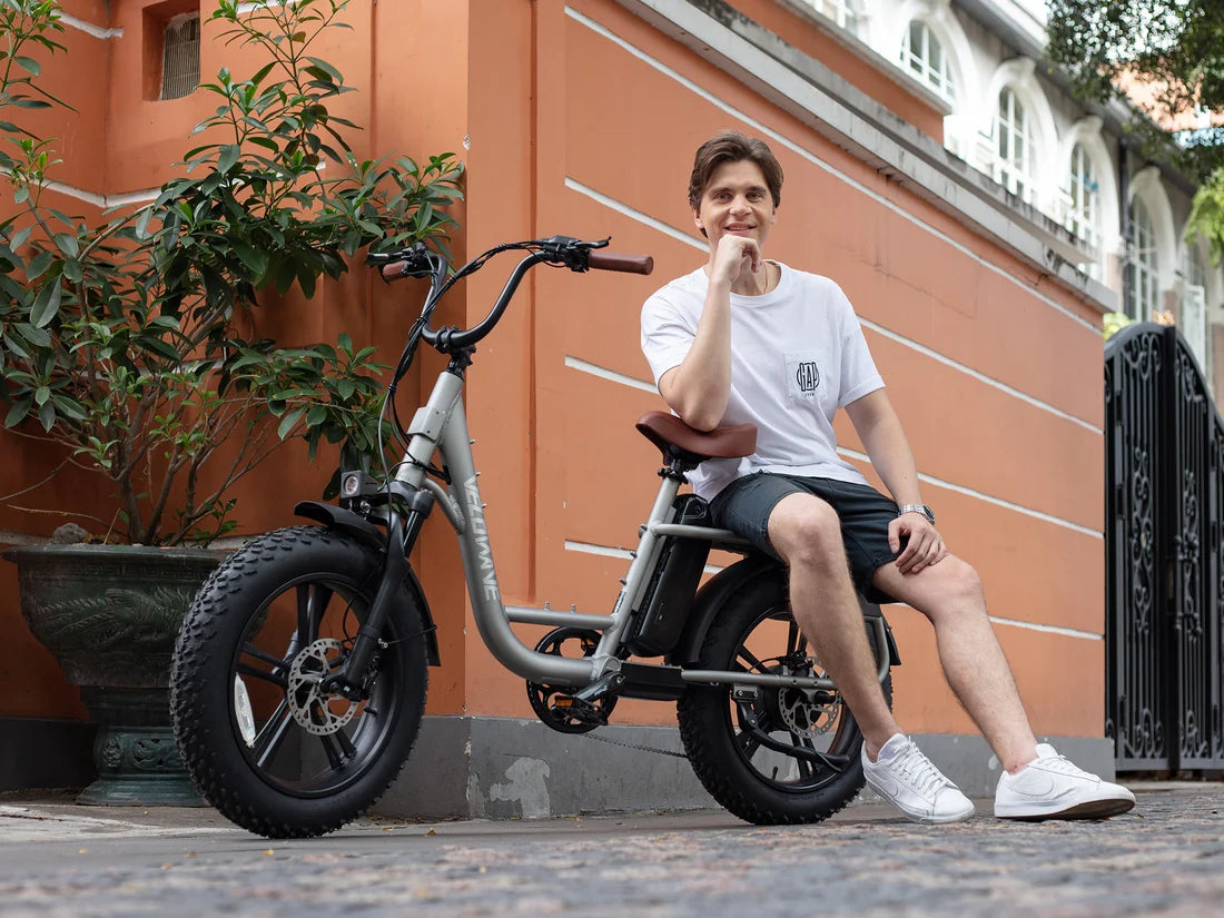 Velowave Prado S Commuter Electric Bike Person sitting on a electric bike in front of a building. Valowave Prado S Commuter Electric Bike