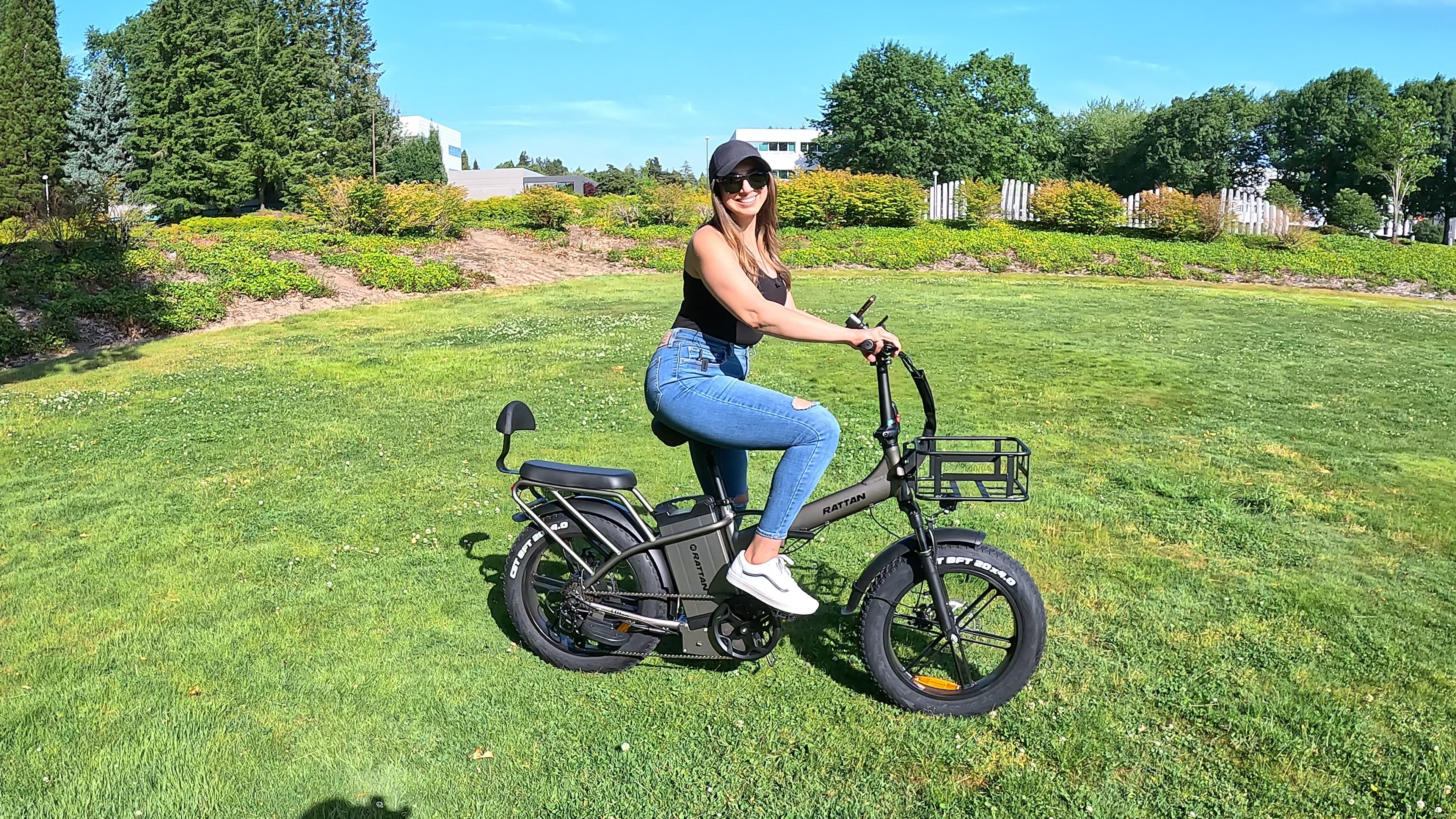 Rattan LM Ultra Folding ebike Woman riding an electric bike in a park. Rattan LM Ultra Folding ebike