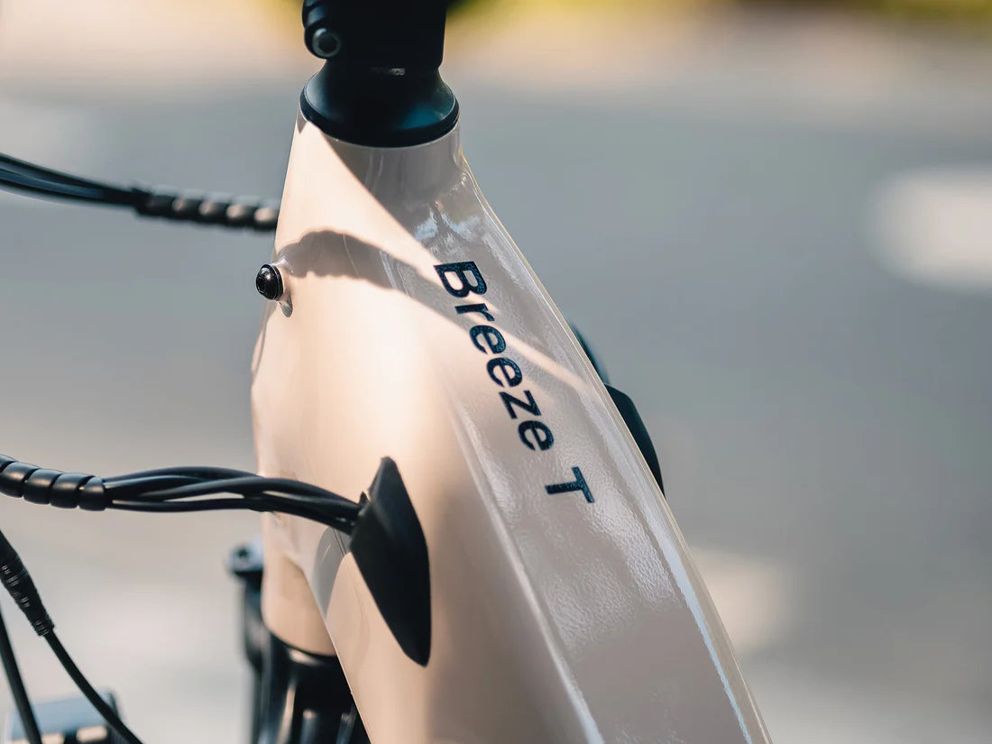 Velowave Breeze T Torque Sensor Electric Bike Close-up of a bicycle with 'Breeze T' branding on a blurred background. Valowave Breeze T Torque Sensor Electric Bike