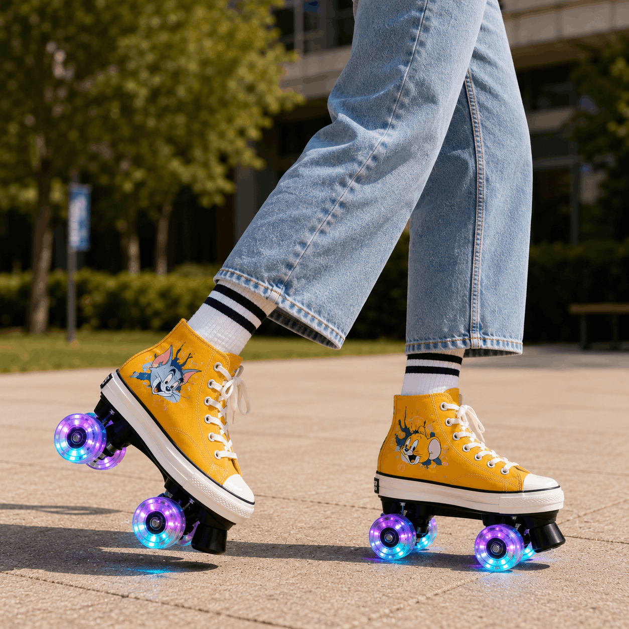 Retro Cartoon Yellow Quad Skating Double Row Roller Skates A person wearing yellow high-top roller skate shoes with colorful LED wheels, light blue jeans, and striped socks, shown outdoors on a paved path.