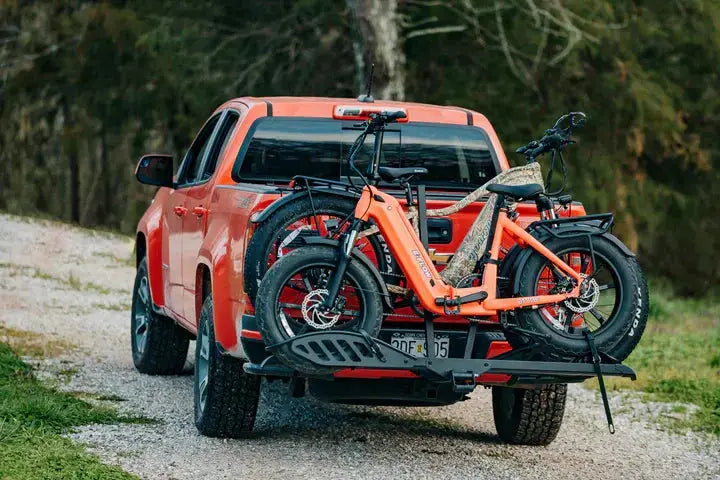 YOUNG Electric E-Flow 750W Folding eBike Orange pickup truck with a bike on a trailer in a forest setting. YOUNG Electric E-Flow 750W Folding eBike
