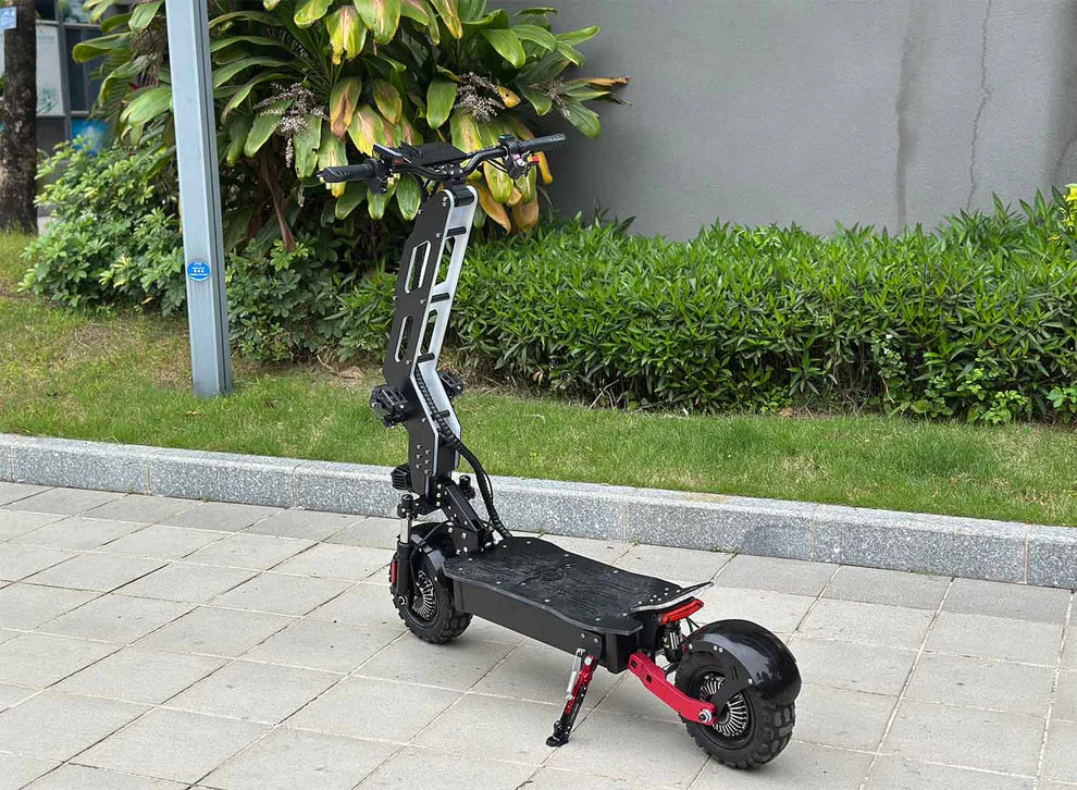 Freego D11 Landtiger Electric Scooter Foldable Dual Motor 4000W Black electric scooter on a sidewalk with greenery in the background. Freego D11 Landtiger Electric Scooter Foldable Dual Motor 4000W