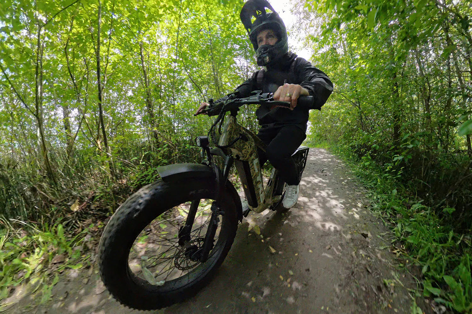 CYKE Cheetah Hunting EBike Person riding a fat-tire bike on a forest path. CYKE Cheetah Hunting EBike