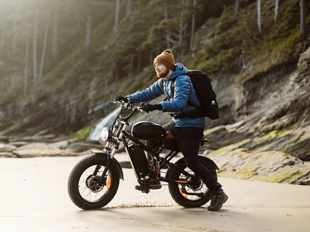 Freego Flash F3 Pro Max Dual Motor and Battery eBike Person on a motorcycle with a backpack in a natural setting. Freego Flash F3 Pro Max Dual Motor and Battery eBike