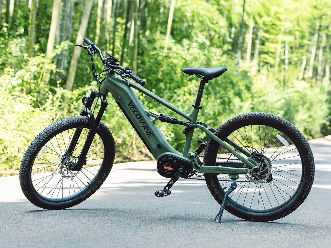 Velowave Forest XM MTB Green electric bike on a road with trees in the background. Valowave Forest XM MTB