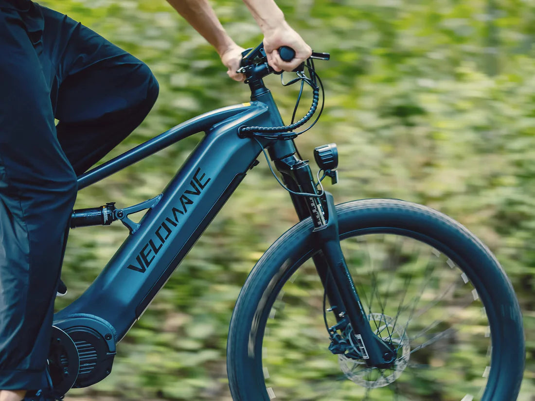 Velowave Forest XM MTB Blue electric bike with Velowave branding on a blurred green . Valowave Forest XM MTBbackground
