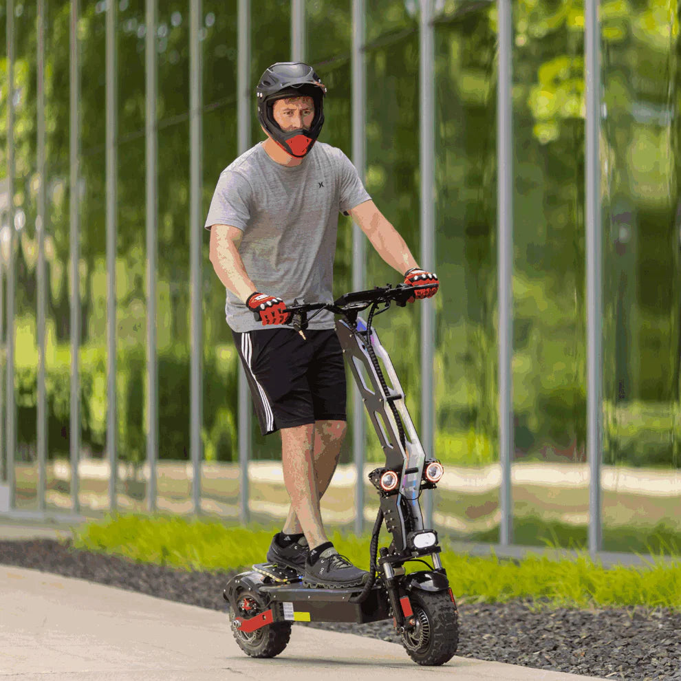 Freego D11 Landtiger Electric Scooter Foldable Dual Motor 4000W Man riding an electric scooter outdoors with a blurred background. Freego D11 Landtiger Electric Scooter Foldable Dual Motor 4000W