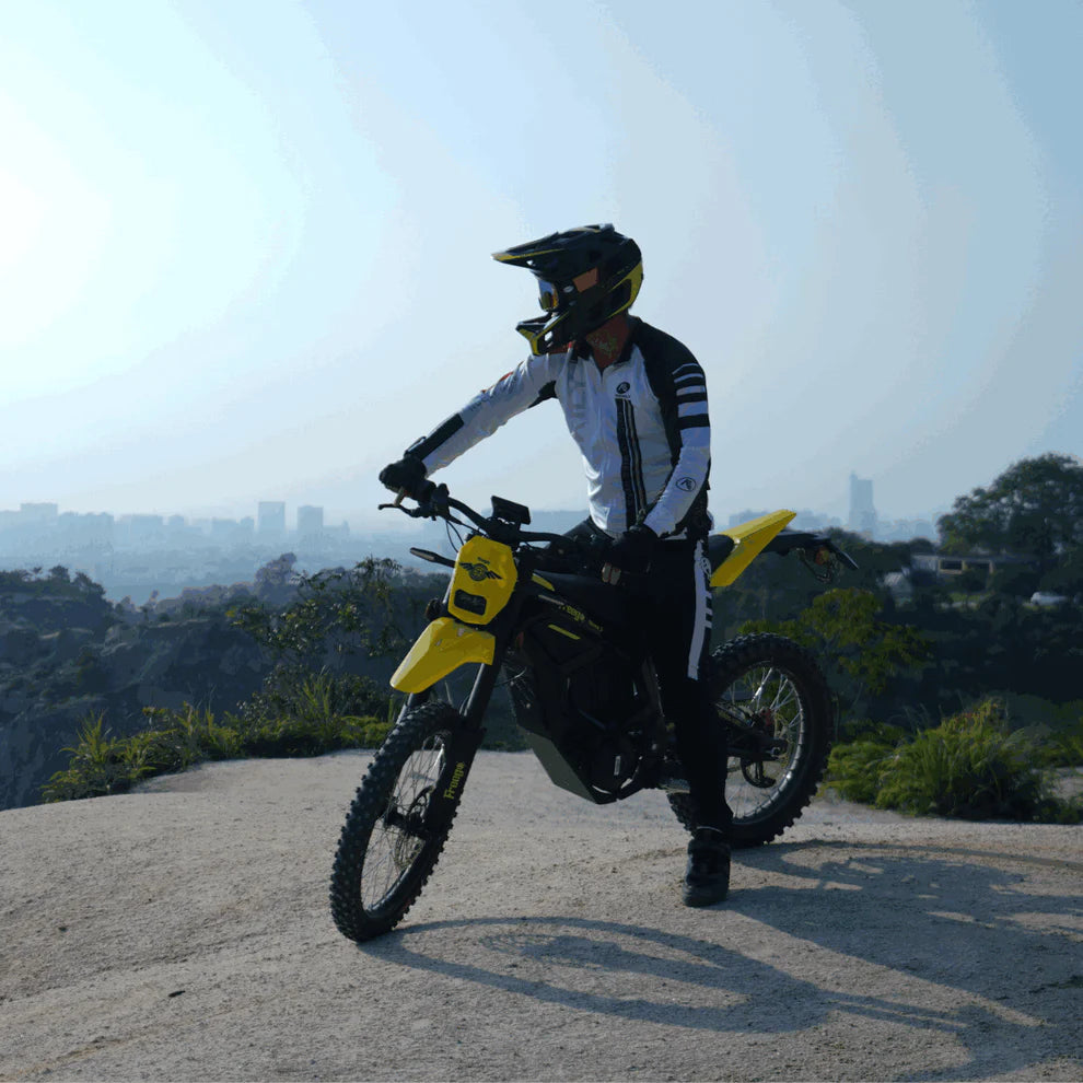 Freego Nova 5 Mid-Drive Off-Road Electric Dirt Bike Person on a yellow motorcycle with a cityscape in the background. Freego Nova 5 Mid-Drive Off-Road Electric Dirt Bike