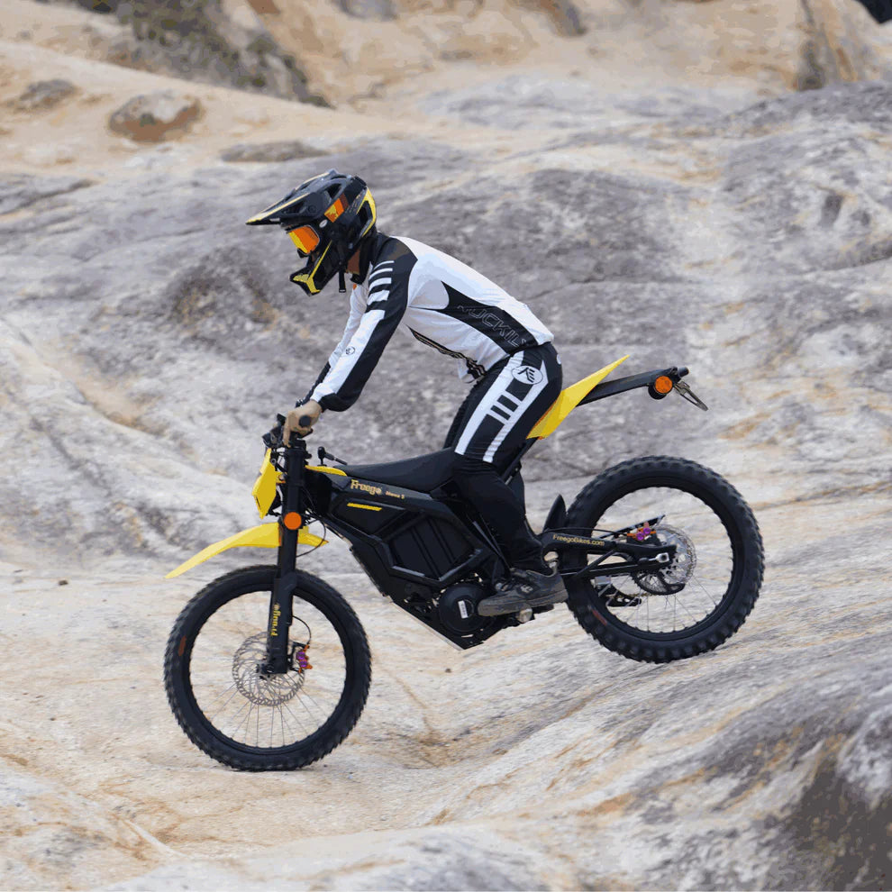 Freego Nova 5 Mid-Drive Off-Road Electric Dirt Bike Person riding a yellow and black electric bike on rocky terrain.Freego Nova 5 Mid-Drive Off-Road Electric Dirt Bike