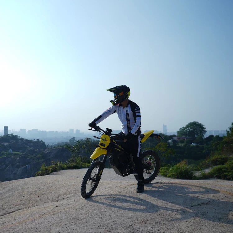 Freego Nova 5 Mid-Drive Off-Road Electric Dirt Bike Person on a yellow motorcycle with a cityscape in the background. Freego Nova 5 Mid-Drive Off-Road Electric Dirt Bike