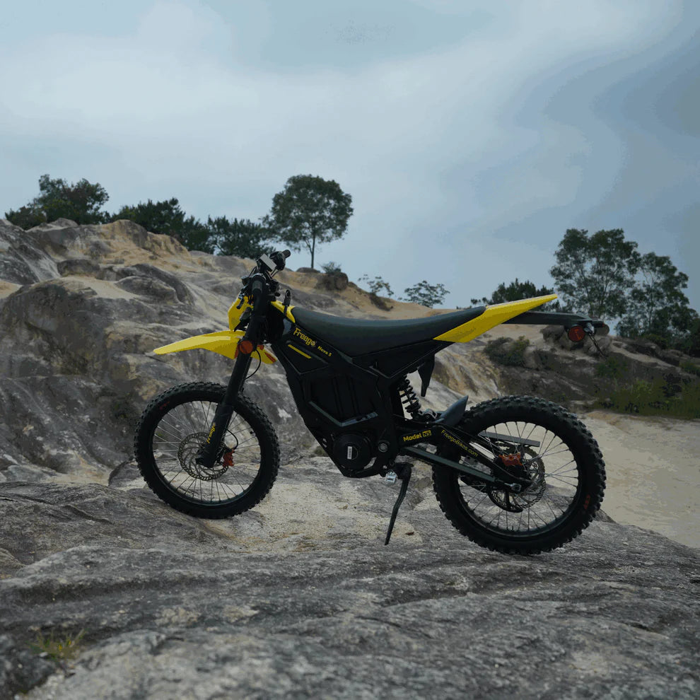 Freego Nova 5 Mid-Drive Off-Road Electric Dirt Bike Yellow and black off-road motorcycle on a rocky terrain with trees in the background. Freego Nova 5 Mid-Drive Off-Road Electric Dirt Bike