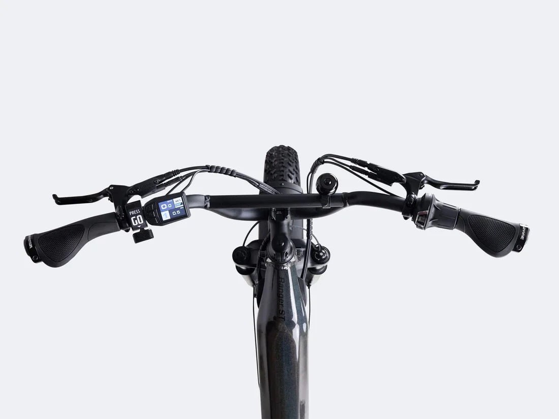 Velowave Ranger Step-Thru 3.0 Torque Sensor Electric Bike Close-up of a bicycle handlebar with control buttons on a white background. Valowave Ranger Step-Thru 3.0 Torque Sensor Electric Bike