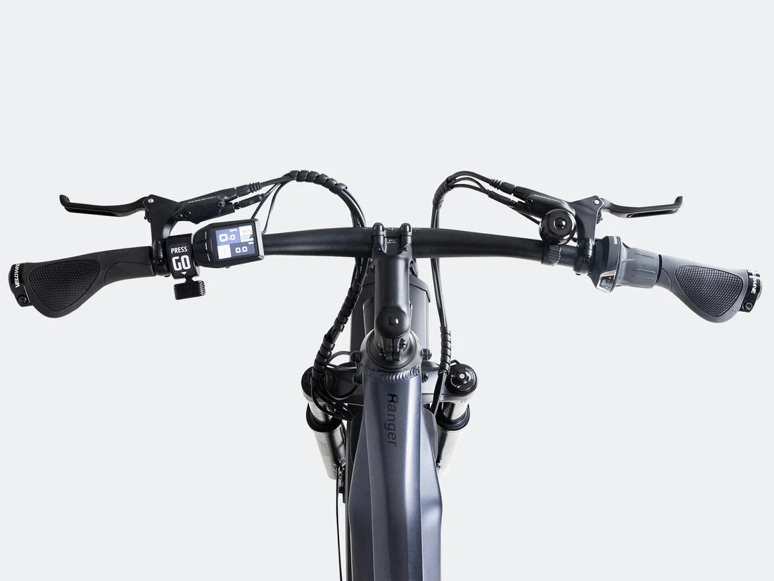 Velowave Ranger 3.0 Fat Tire All-Terrain Electric Bike Close-up of a bicycle handlebar with control buttons on a white background. Valowave Ranger 3.0 Fat Tire All-Terrain Electric Bike