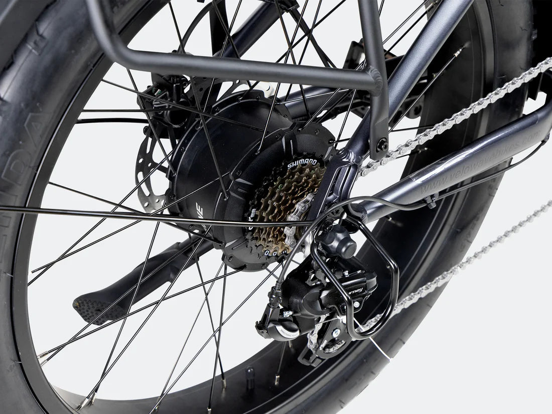 Velowave Ranger 3.0 Fat Tire All-Terrain Electric Bike Close-up of a bicycle wheel with gear and chain on a white background. Valowave Ranger 3.0 Fat Tire All-Terrain Electric Bike