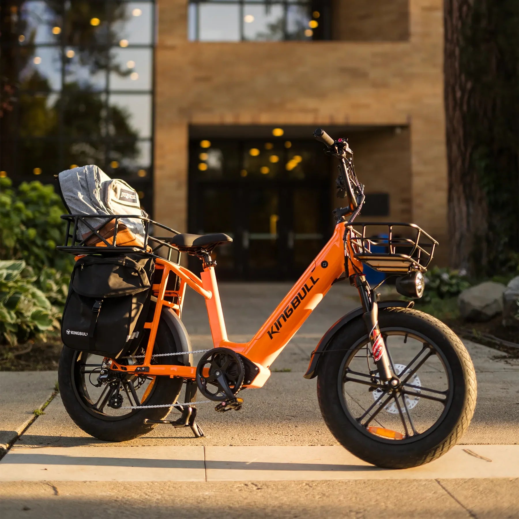 Kingbull Voyager 2.0 Fat Tire Electric Cargo Bike Orange electric bike with accessories parked on a sidewalk. Kingbull Voyager 2.0 Fat Tire Electric Cargo Bike