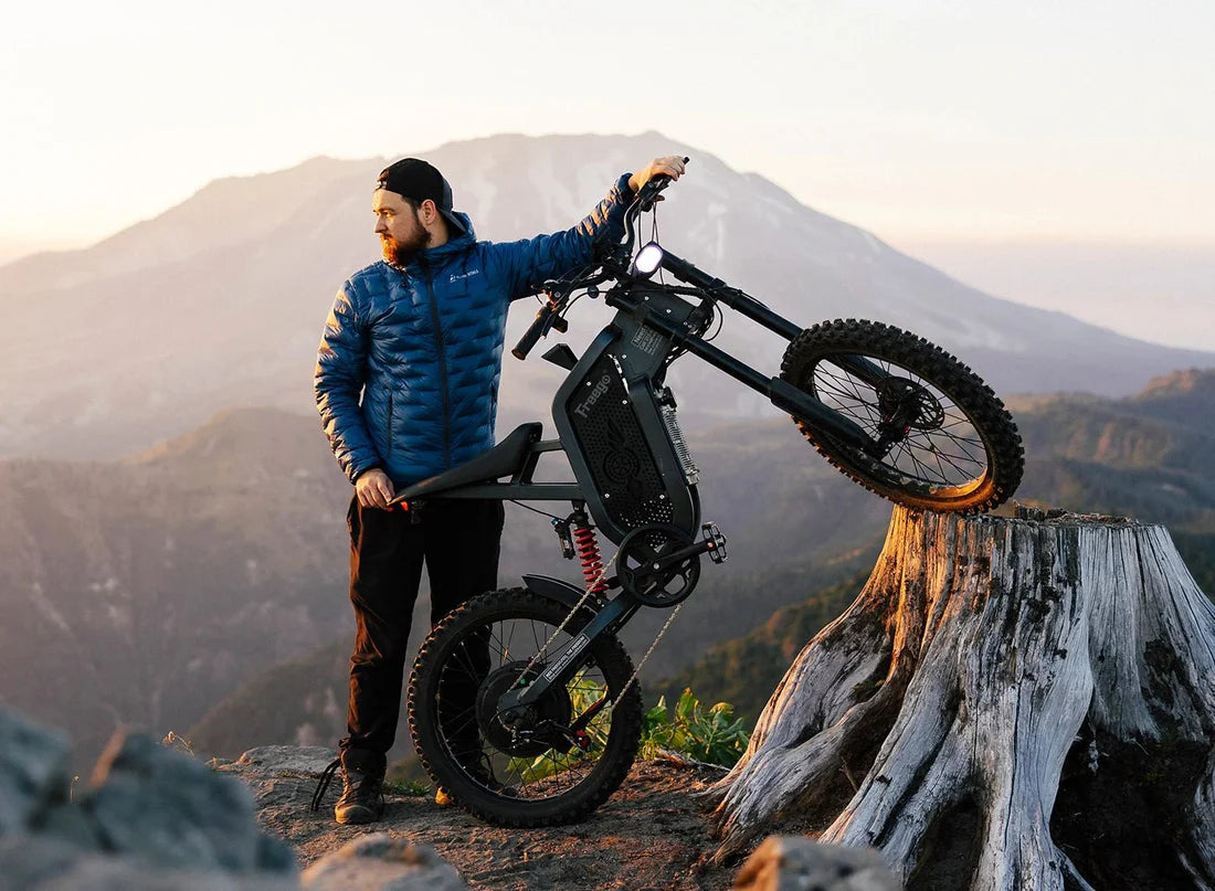 Freego X2 Dirt Master Off-Road eBike Man with an electric bike on a mountainous landscape. Freego X2 Pro All-Terrain Dirt eBike