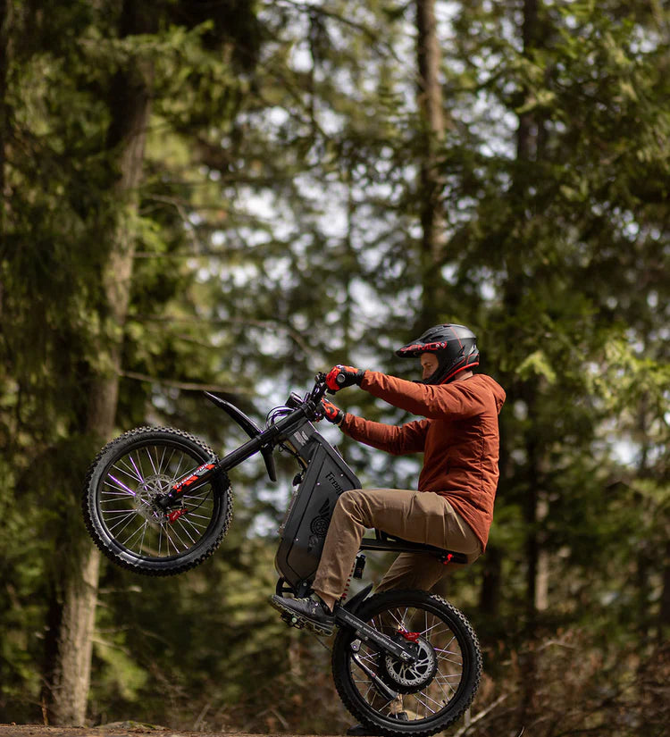 Freego X2 Pro All-Terrain Dirt eBike Person riding a mountain bike in a forest. Freego X2 Pro All-Terrain Dirt eBike
