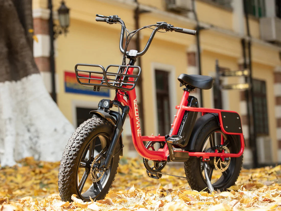 Velowave Prado S Commuter Electric Bike Red electric bike with a basket on a street with autumn leaves. Valowave Prado S Commuter Electric Bike