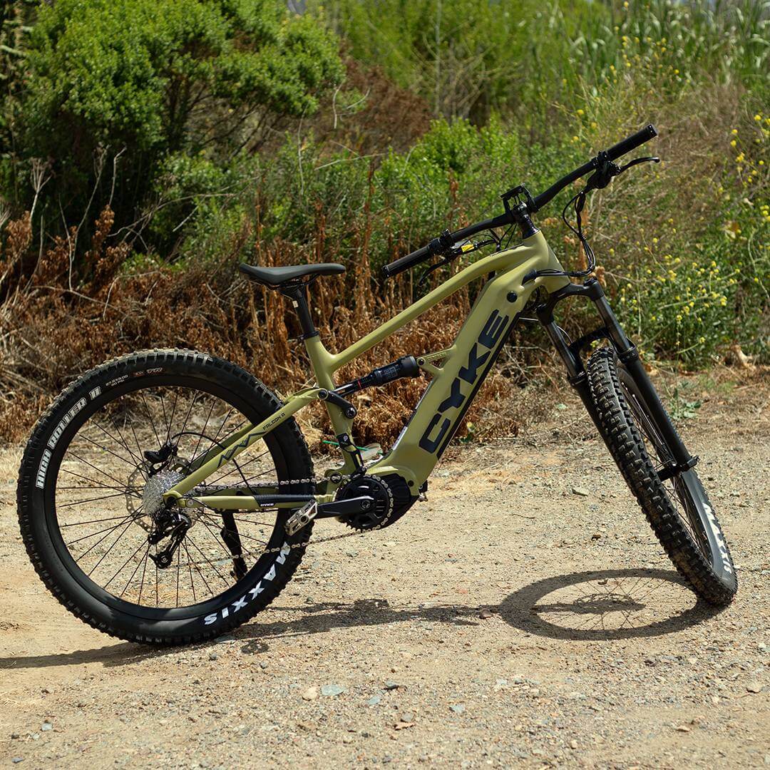 CYKE Falcon A Full Suspension eBike Electric bike on a dirt path with greenery in the background. CYKE Falcon A Full Suspension eBike