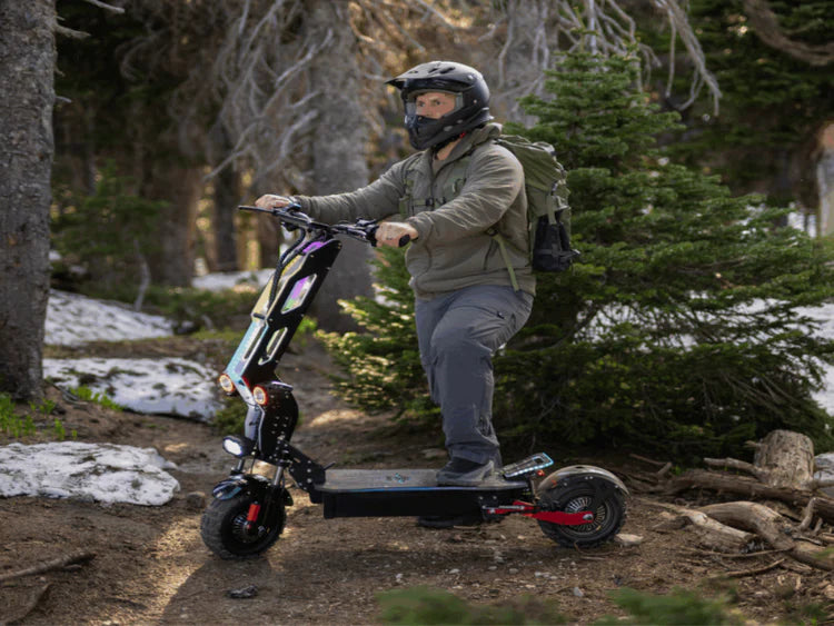 Freego D11 Landtiger Electric Scooter Foldable Dual Motor 4000W Person riding an electric scooter in a forested area. Freego D11 Landtiger Electric Scooter Foldable Dual Motor 4000W