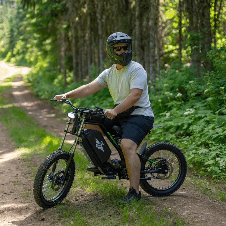 Freego Nova 3 Mid-Drive All-Terrain Dirt eBike Man riding a electric bike on a forest path. Freego Nova 3 Mid-Drive All-Terrain Dirt eBike