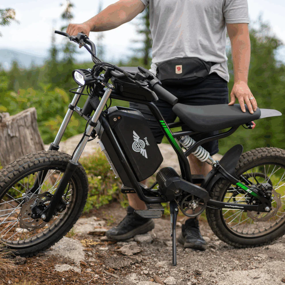 Freego Nova 3 Mid-Drive All-Terrain Dirt eBike Person standing next to an electric bike on a trail with greenery in the background Freego Nova 3 Mid-Drive All-Terrain Dirt eBike