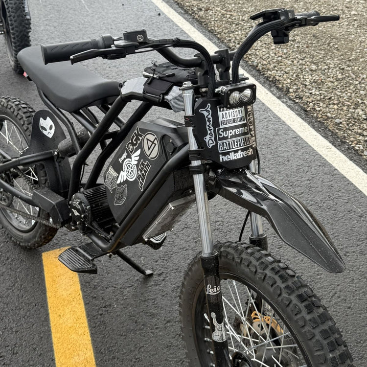 Freego Nova 5 Mid-Drive Off-Road Electric Dirt Bike Black electric bike with visible branding on a road. Freego Nova 5 Mid-Drive Off-Road Electric Dirt Bike