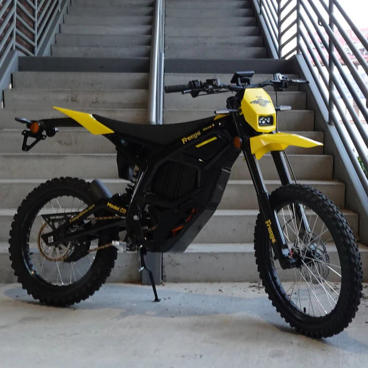 Freego Nova 5 Mid-Drive Off-Road Electric Dirt Bike Black and yellow electric bike on a concrete floor with stairs in the background. Freego Nova 5 Mid-Drive Off-Road Electric Dirt Bike