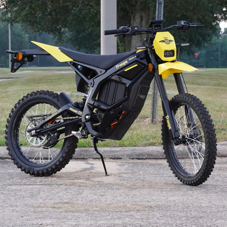 Freego Nova 5 Mid-Drive Off-Road Electric Dirt Bike Black and yellow electric bike on a paved surface with grass and trees in the background. Freego Nova 5 Mid-Drive Off-Road Electric Dirt Bike