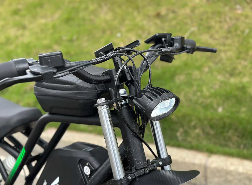 Freego Nova 3 Mid-Drive All-Terrain Dirt eBike Close-up of a motorcycle handlebar with a blurred grassy background. Freego Nova 3 Mid-Drive All-Terrain Dirt eBike