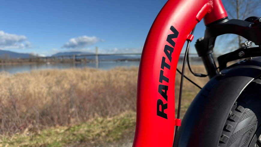 Red bicycle frame with 'Rattan' branding against a natural background. Rattan LF Ultra Folding ebike