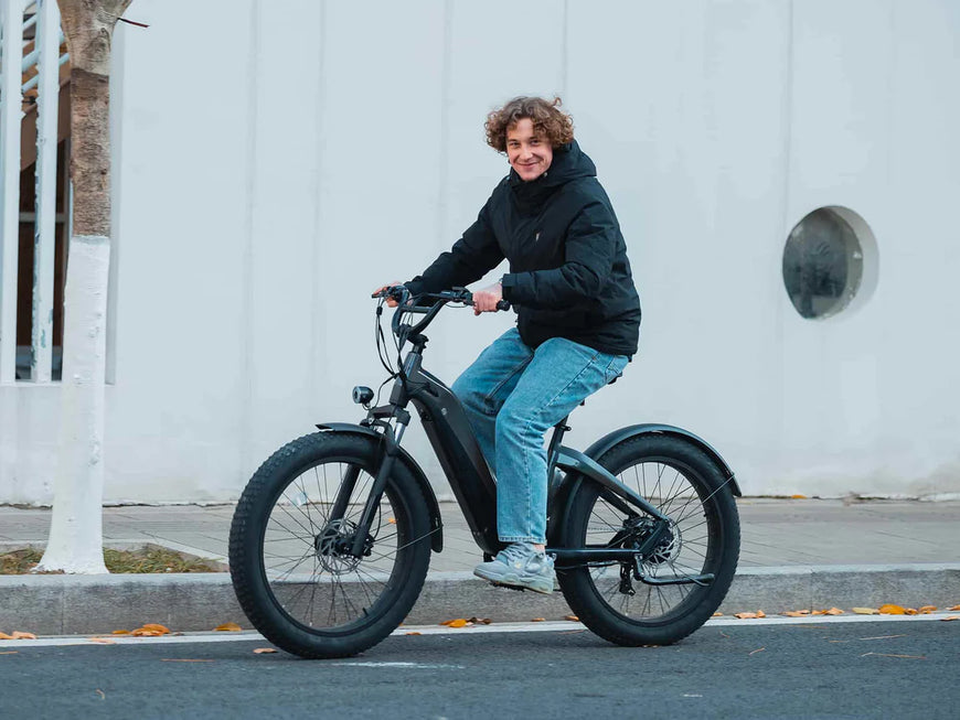 Person riding an electric bike on a city street. Valowave Grace 2.0 Step-Thru Electric Bike