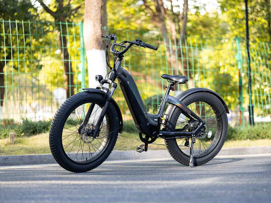 Black electric bike on a road with greenery in the background. Valowave Grace 2.0 Step-Thru Electric Bike