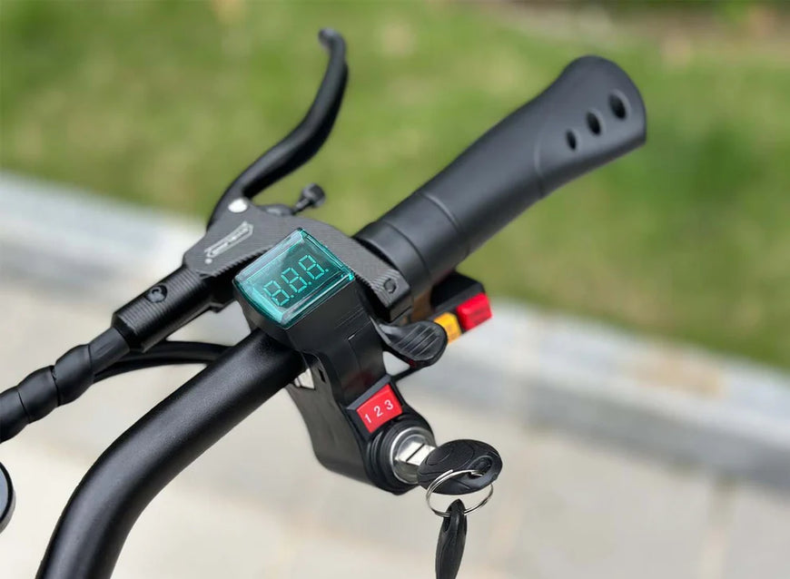 Close-up of a motorcycle handlebar with digital display and control buttons. Freego D11 Landtiger Electric Scooter Foldable Dual Motor 4000W