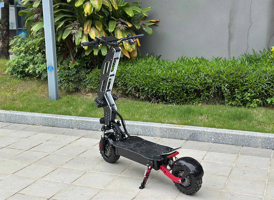 Black electric scooter on a sidewalk with greenery in the background. Freego D11 Landtiger Electric Scooter Foldable Dual Motor 4000W