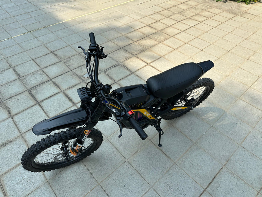 Black electric bike on a tiled pavement. Natkie N1 All-Terrain Electric Motorcycle