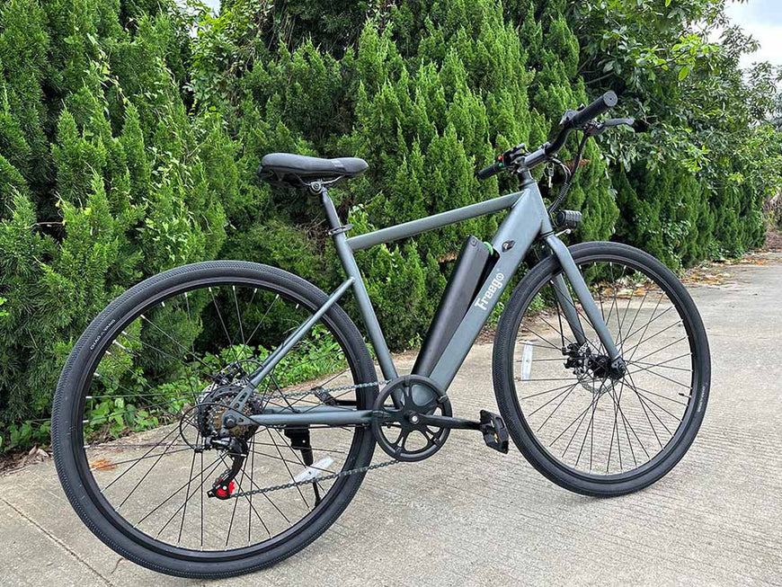 Gray electric bicycle parked on a paved path with greenery in the background. Freego E7 Electric Bicycle For City Commuting