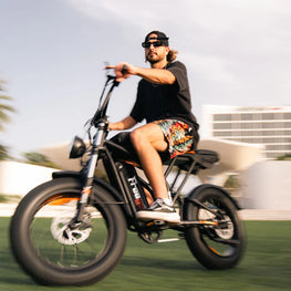 Man riding an electric bike on a blurred background. Freego Shotgun Prime F2 Pro Electric Cargo Bike