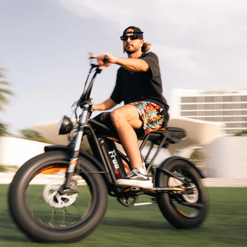 Man riding an electric bike on a blurred background. Freego Shotgun Prime F2 Pro Electric Cargo Bike