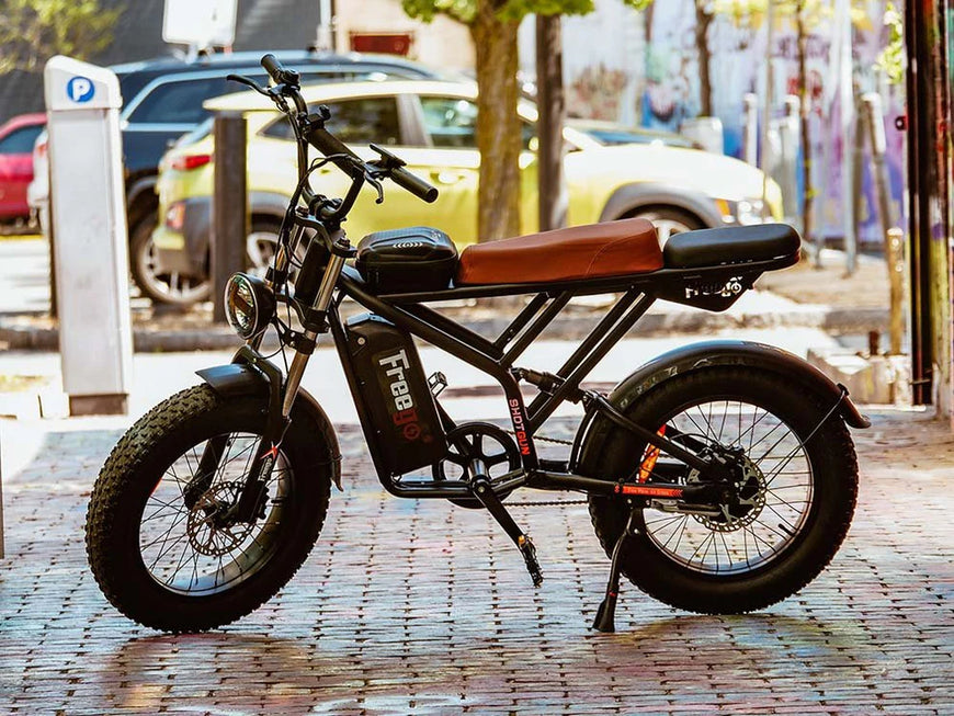 Electric bike on a city street with cars and trees in the background. Freego Shotgun Prime F2 Pro Electric Cargo Bike