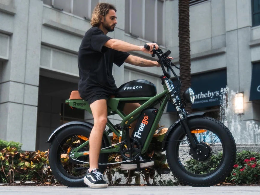 Man riding a green electric bike with 'FREEGO' branding in an urban setting. Freego Flash F3 Pro Dual Motor and Battery eBike