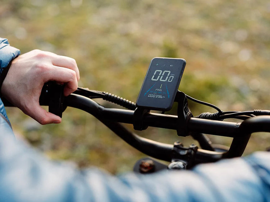 Digital display on a bicycle handlebar with a blurred natural background. Freego Flash F3 Pro Max Dual Motor and Battery eBike