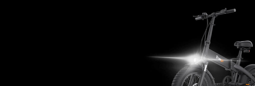 Bicycle with a headlight on a black background. Freego eFlex Raptor E1 Shimano 7-Speed Foldable Fat Tire City Electric Bike