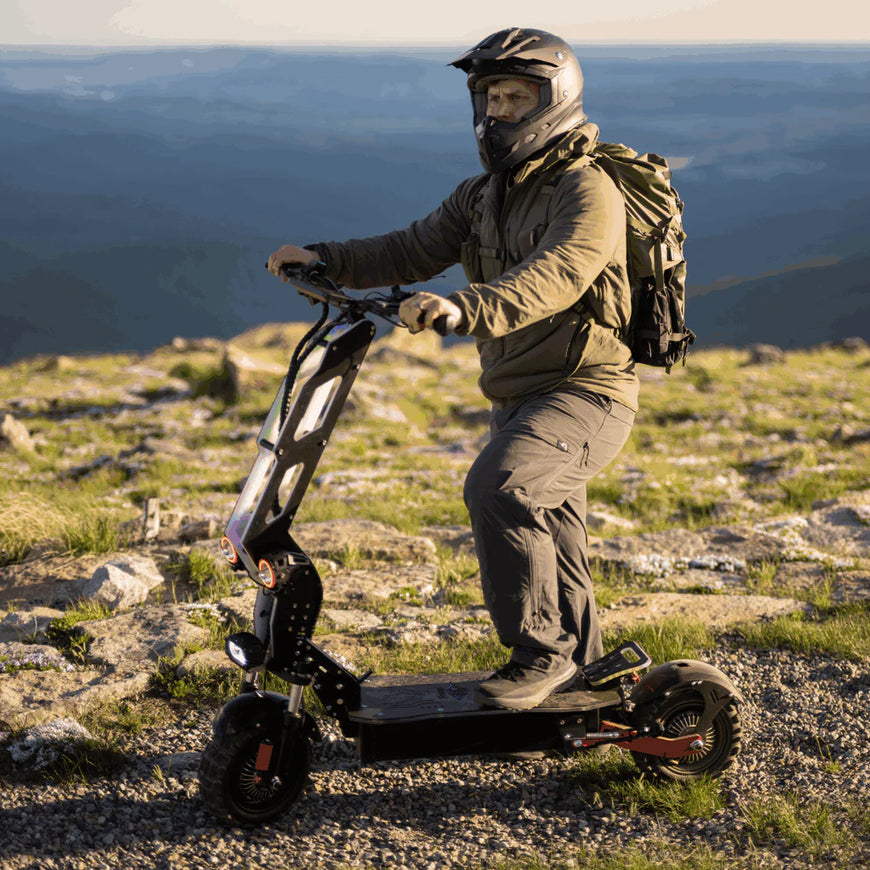 Person riding an electric scooter on a mountain with a scenic background. Freego D11 Landtiger Electric Scooter Foldable Dual Motor 4000W