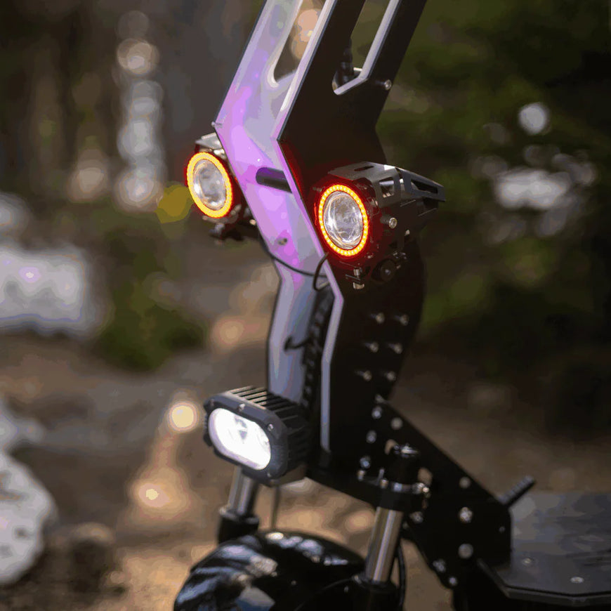 Close-up of a motorcycle headlight with blurred background. Freego D11 Landtiger Electric Scooter Foldable Dual Motor 4000W